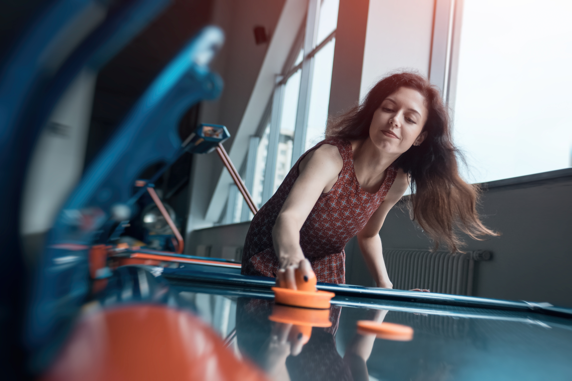 woman playing air hockey