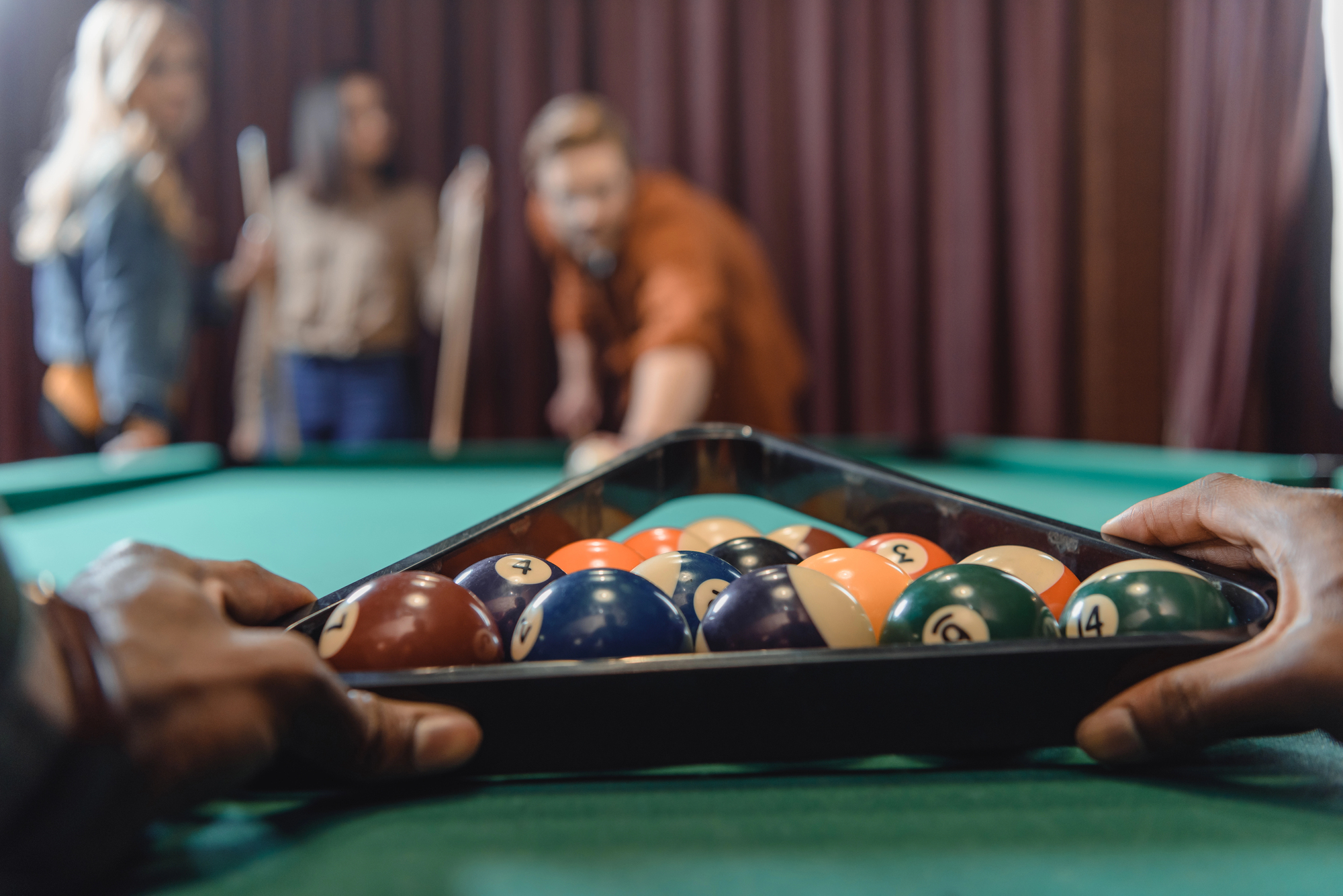 Cropped image of male hands forming set of billiard balls