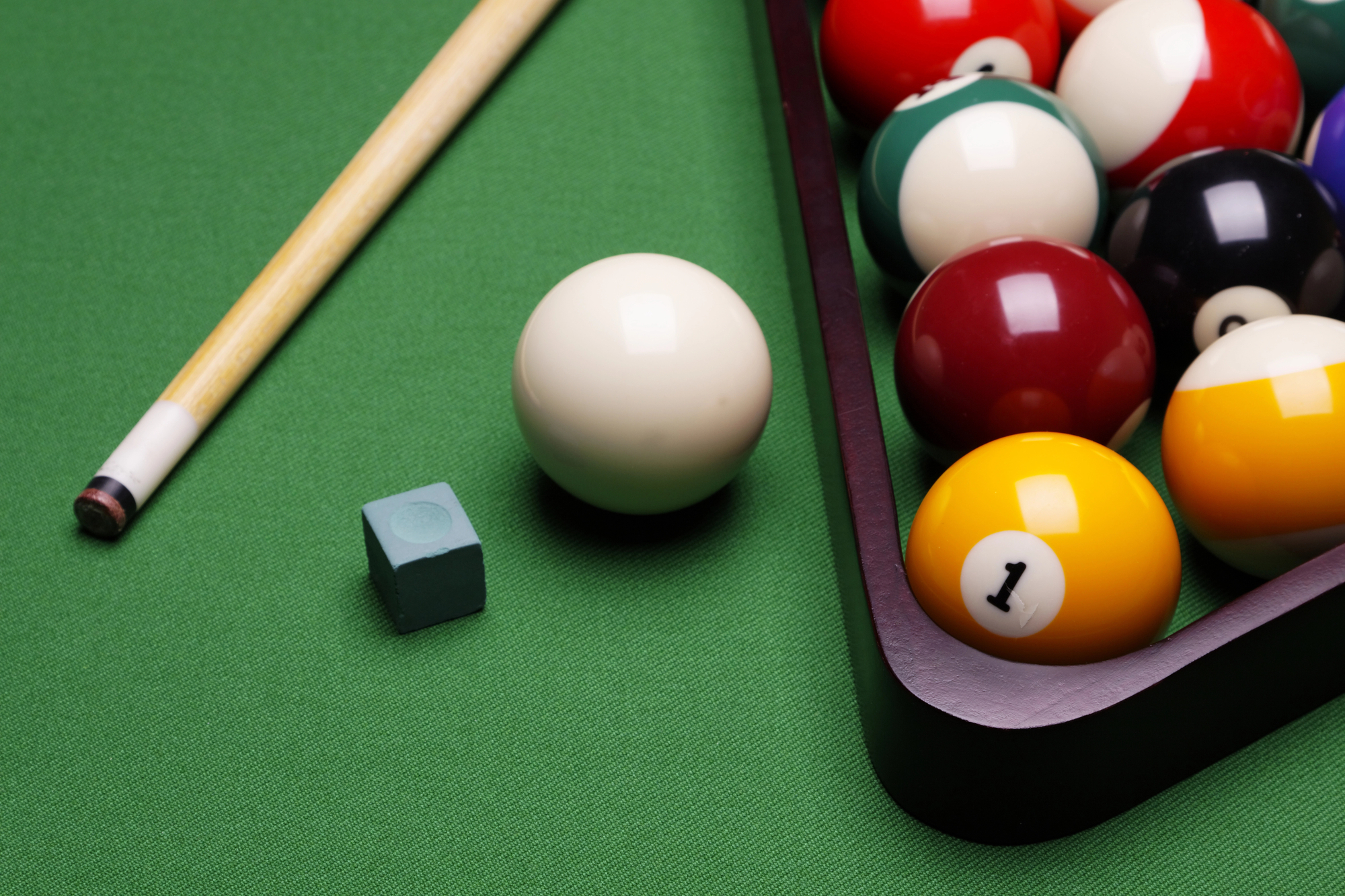 pool cue and balls in the background
