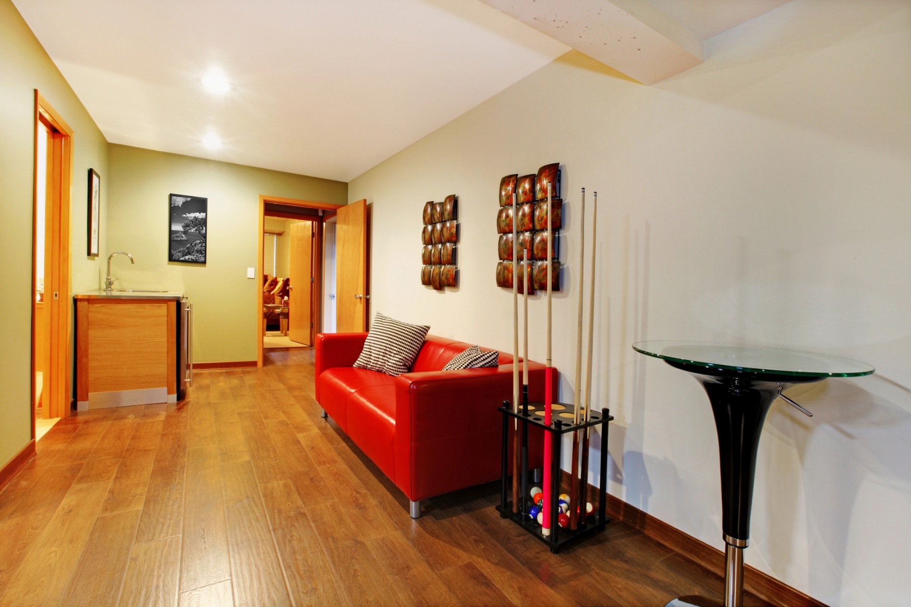 An image showcasing a floor pool cue rack in a stylish game room setting, ideal for pool player gifts